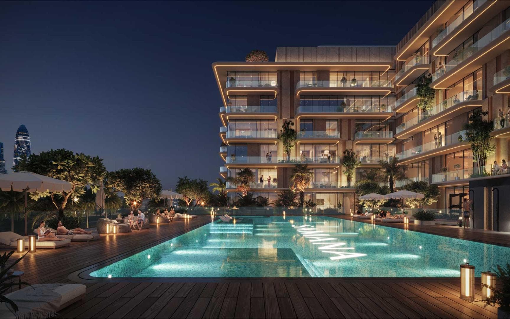 Illuminated pool deck at night surrounded by loungers and terraced residences
