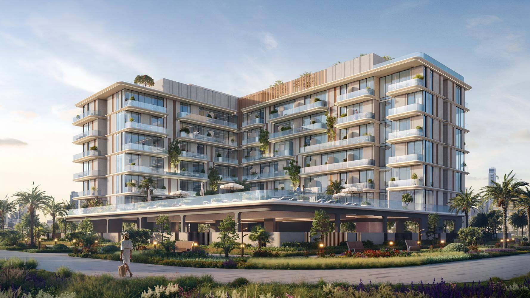 مشروع SAMANA South Haven 2 في ضوء النهار، مبنى سكني متدرّج تحيط به أشجار النخيل والحدائق